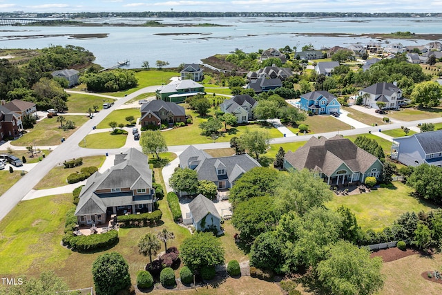 aerial perspective of suburban area with a nearby body of water
