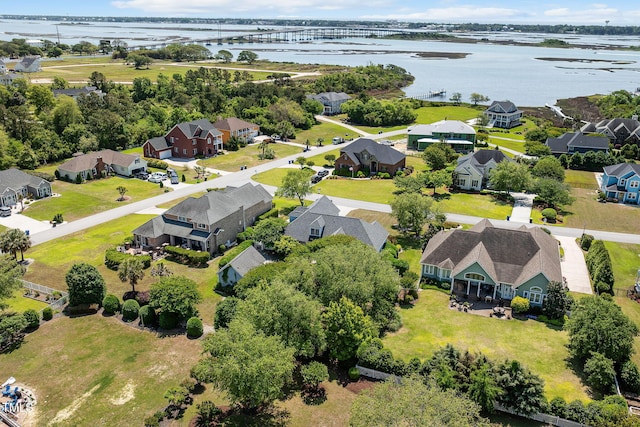 aerial perspective of suburban area featuring a notable bridge and a large body of water