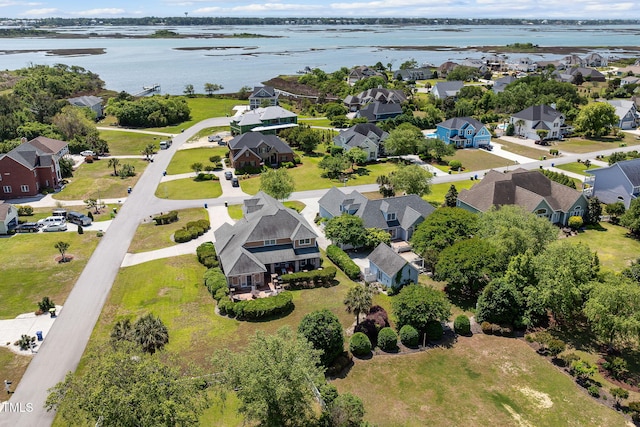 aerial perspective of suburban area with a nearby body of water