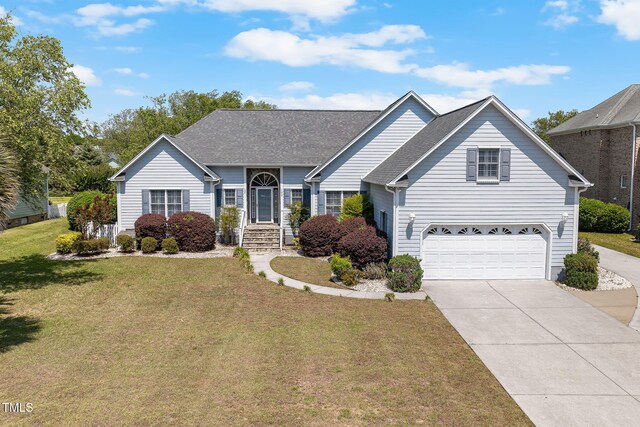 view of front of home featuring concrete driveway, a front yard, a garage, and a shingled roof