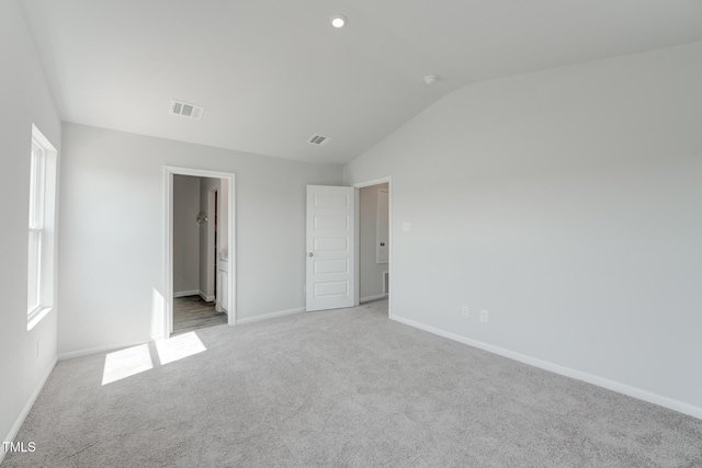 124 Landon Pl, Roxboro, NC 27573 - unfurnished bedroom featuring visible vents, carpet flooring, baseboards, and vaulted ceiling