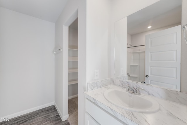 124 Landon Pl, Roxboro, NC 27573 - bathroom with vanity, baseboards, walk in shower, and wood finished floors