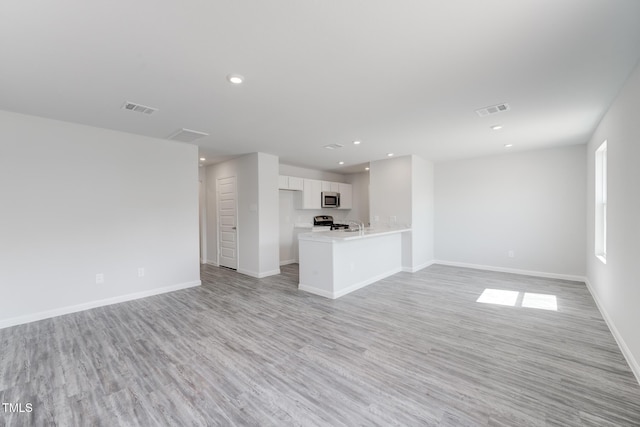 124 Landon Pl, Roxboro, NC 27573 - unfurnished living room with visible vents, recessed lighting, light wood-style floors, and baseboards