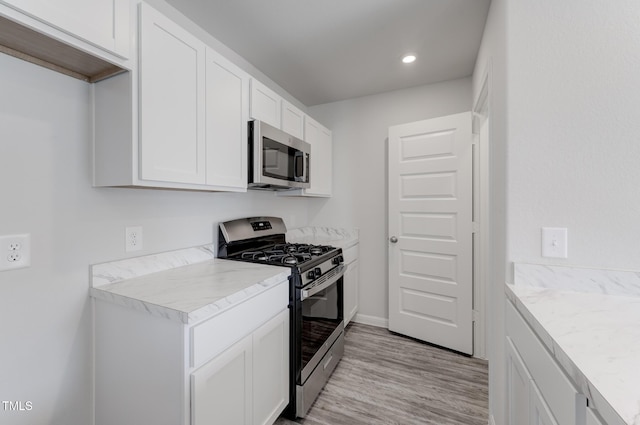 124 Landon Pl, Roxboro, NC 27573 - kitchen with light countertops, white cabinets, light wood finished floors, stainless steel appliances, and recessed lighting