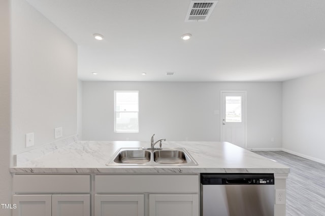 124 Landon Pl, Roxboro, NC 27573 - kitchen with a sink, light wood-style flooring, baseboards, stainless steel dishwasher, and visible vents