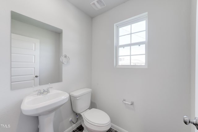 124 Landon Pl, Roxboro, NC 27573 - bathroom with a sink, baseboards, toilet, and visible vents