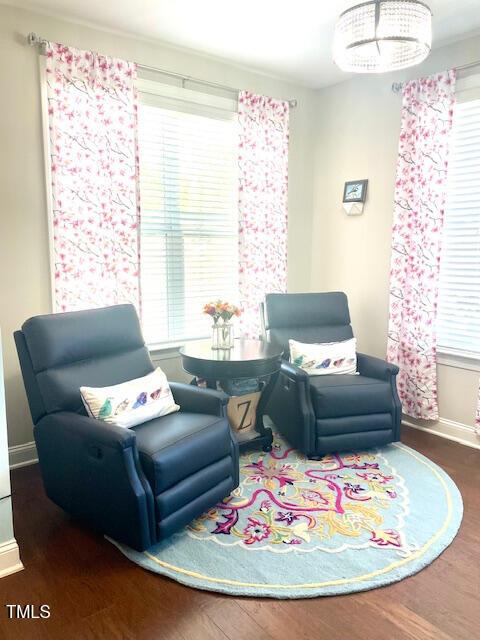 sitting room with baseboards and wood finished floors