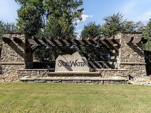 community / neighborhood sign featuring a lawn