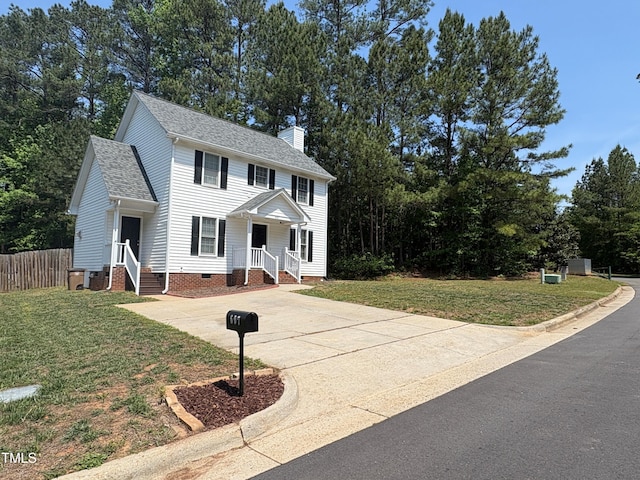 607 Wahlbrink Dr, Wake Forest, NC 27587 - colonial house with crawl space, a chimney, a front yard, fence, and concrete driveway