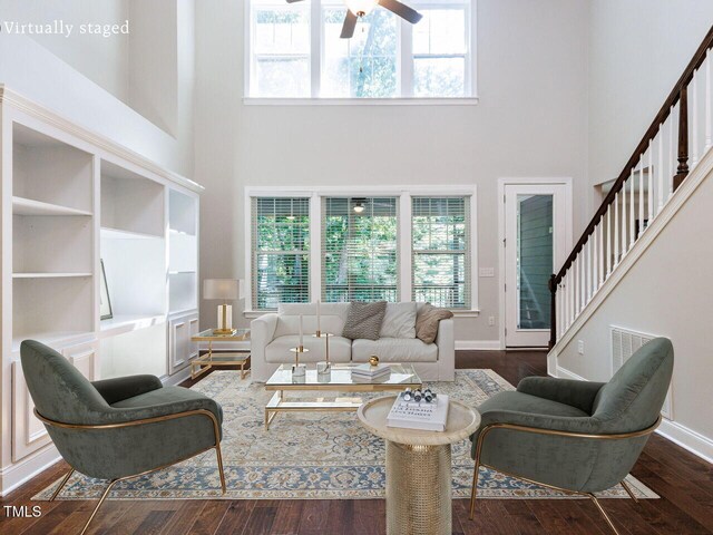 354 Crimson Way, Pittsboro, NC 27312 - living room featuring a high ceiling, wood finished floors, a ceiling fan, and stairs