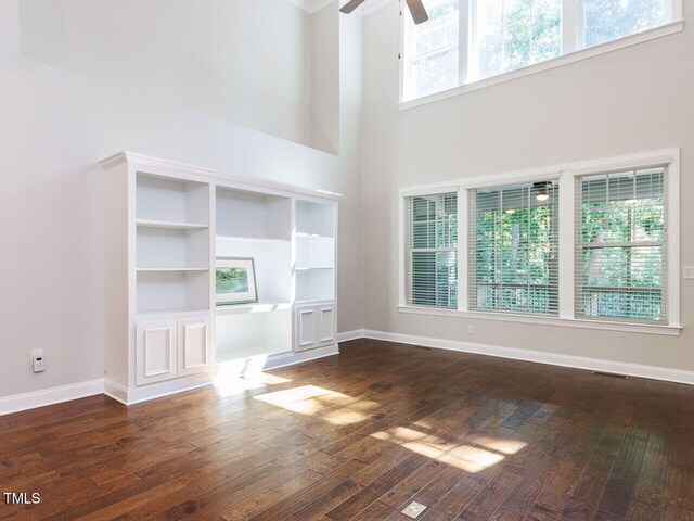 354 Crimson Way, Pittsboro, NC 27312 - unfurnished living room with a ceiling fan, a high ceiling, and dark wood finished floors