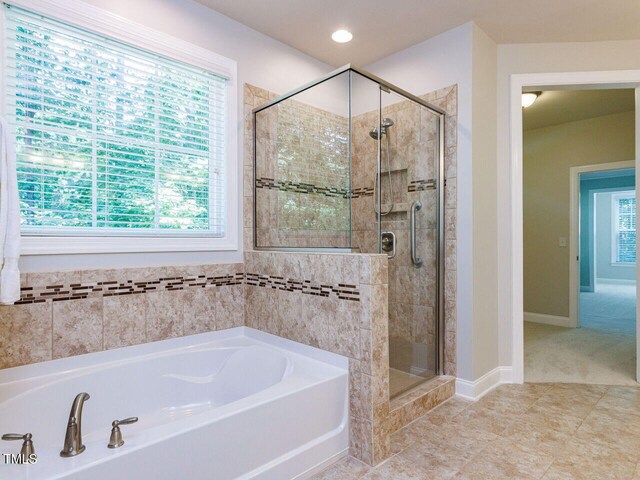 354 Crimson Way, Pittsboro, NC 27312 - full bathroom with a garden tub, a shower stall, plenty of natural light, and tile patterned floors