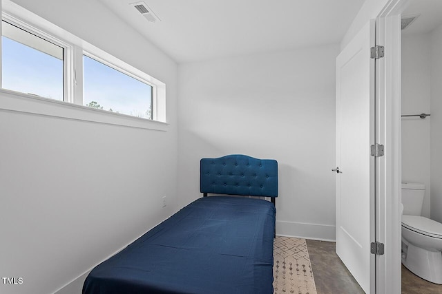 bedroom with baseboards and concrete flooring