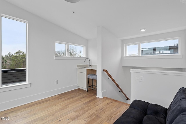 sitting room with an upstairs landing, light wood-style flooring, plenty of natural light, baseboards, and recessed lighting