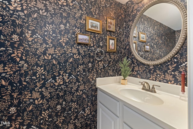 bathroom featuring vanity and wallpapered walls