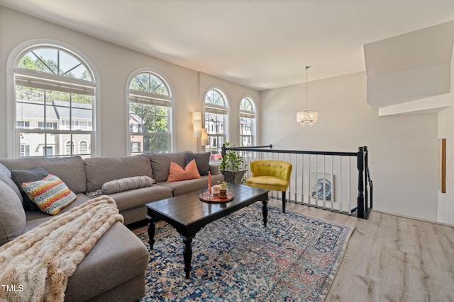 living area with an inviting chandelier and wood finished floors