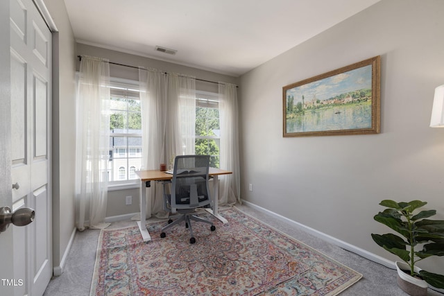 carpeted office featuring baseboards and visible vents