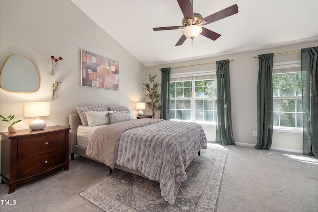 carpeted bedroom featuring baseboards, a ceiling fan, lofted ceiling, and multiple windows