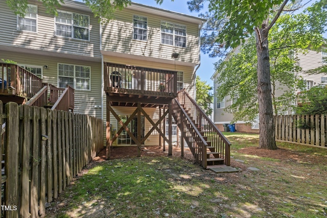 back of house with stairs, fence, a yard, and a deck