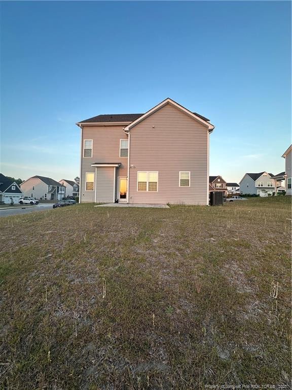 347 Brentmoor Dr, Raeford, NC 28376 - rear view of house with a yard and central AC unit