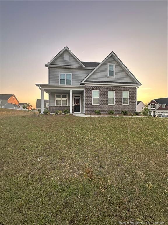 347 Brentmoor Dr, Raeford, NC 28376 - back of house with a lawn, brick siding, and a porch
