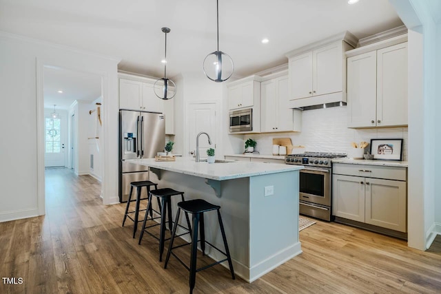 151 Monteith Dr, Chapel Hill, NC 27516 - kitchen featuring stainless steel appliances, a sink, a breakfast bar area, tasteful backsplash, and a center island with sink