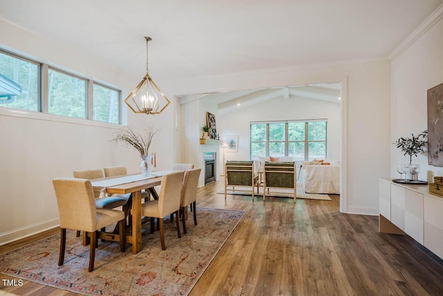 151 Monteith Dr, Chapel Hill, NC 27516 - dining room with a chandelier, wood finished floors, ornamental molding, a glass covered fireplace, and baseboards
