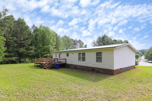 1201 Red Sunset Pl, Siler City, NC 27344 - rear view of property with a yard, a wooden deck, metal roof, and crawl space