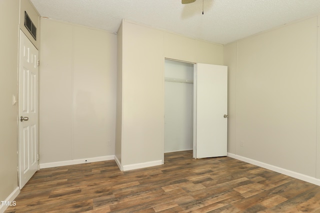 1201 Red Sunset Pl, Siler City, NC 27344 - unfurnished bedroom with dark wood-style flooring, a closet, visible vents, and a textured ceiling