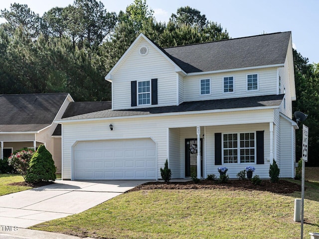 traditional home featuring a porch, driveway, a front lawn, and a garage