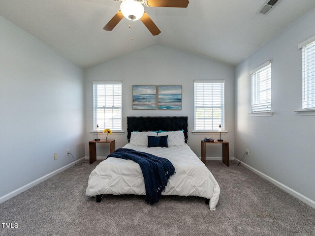 bedroom featuring vaulted ceiling, multiple windows, baseboards, and carpet flooring