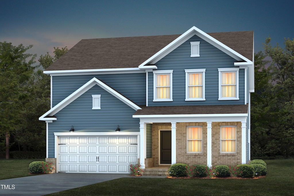 traditional home with an attached garage, roof with shingles, covered porch, and driveway