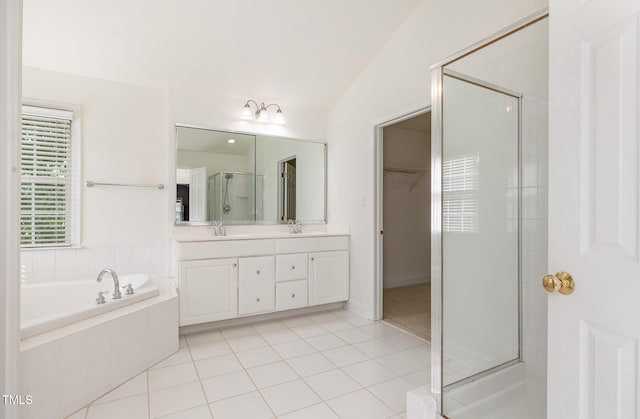 bathroom featuring a sink, double vanity, a shower stall, and a bath
