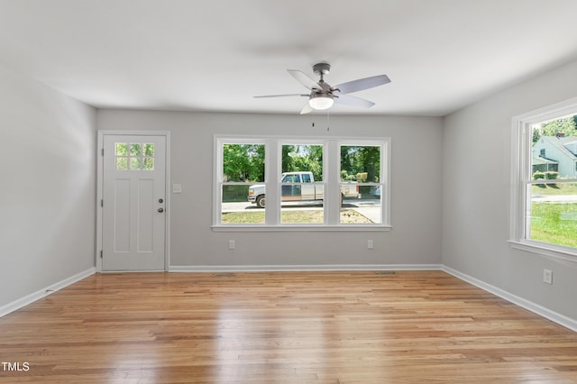 entrance foyer featuring a ceiling fan, light wood finished floors, and baseboards