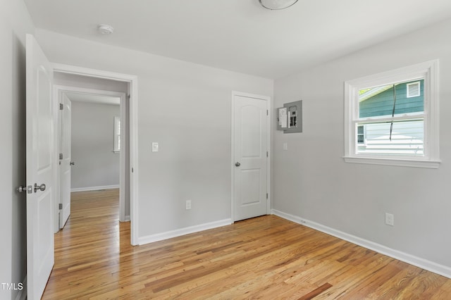 unfurnished bedroom featuring light wood-type flooring and baseboards