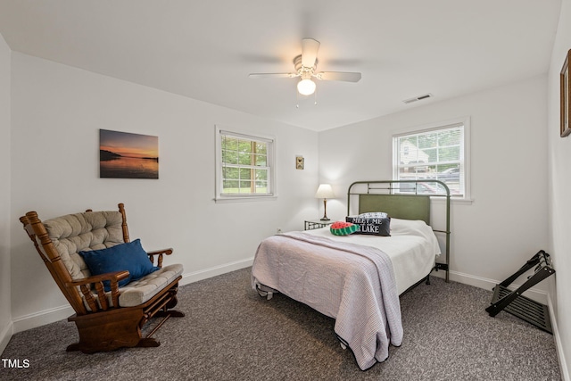 carpeted bedroom featuring visible vents, a ceiling fan, baseboards, and multiple windows