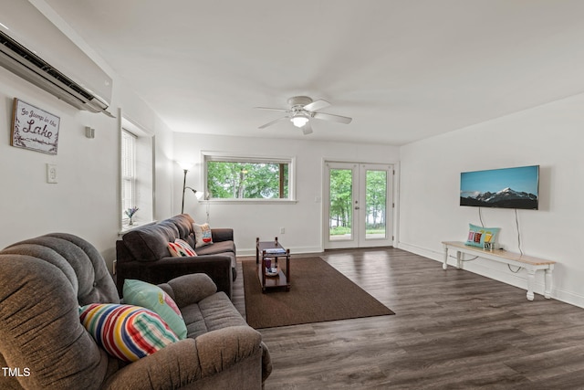 living area featuring baseboards, ceiling fan, an AC wall unit, and wood finished floors