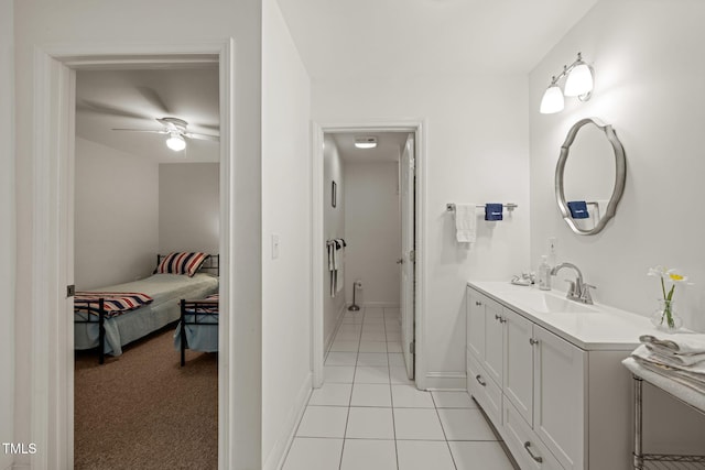 bathroom with tile patterned flooring, a ceiling fan, baseboards, and vanity