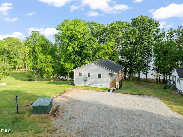 view of property exterior with a lawn, driveway, and crawl space