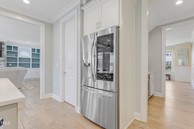 kitchen featuring light countertops, stainless steel fridge with ice dispenser, ornamental molding, recessed lighting, and white cabinetry
