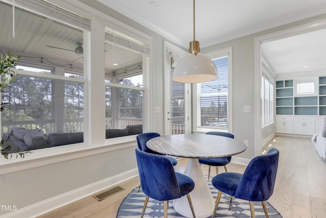 dining area with baseboards, wood finished floors, and visible vents