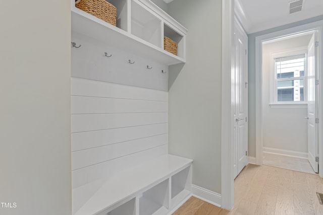 mudroom with visible vents, light wood finished floors, and baseboards