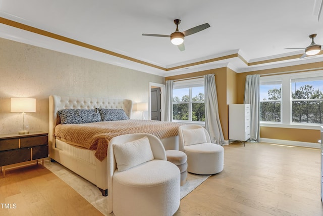 bedroom with crown molding, a ceiling fan, and light wood-style flooring