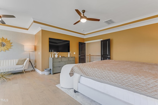 bedroom featuring crown molding, ceiling fan, visible vents, and wood finished floors
