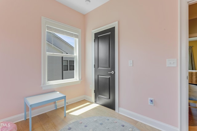 entryway featuring baseboards and wood finished floors