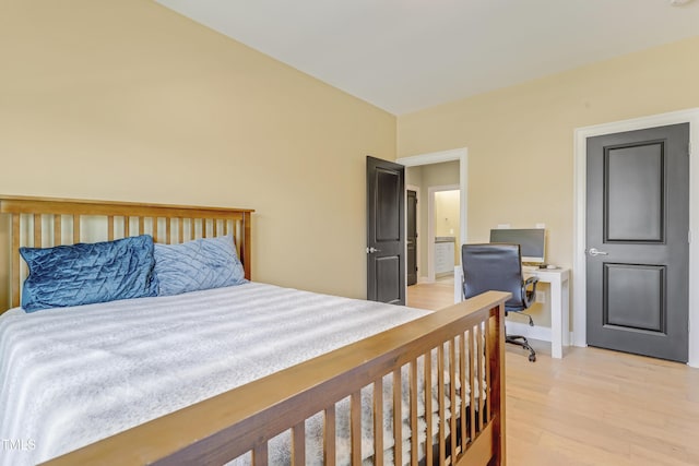bedroom with baseboards and light wood finished floors