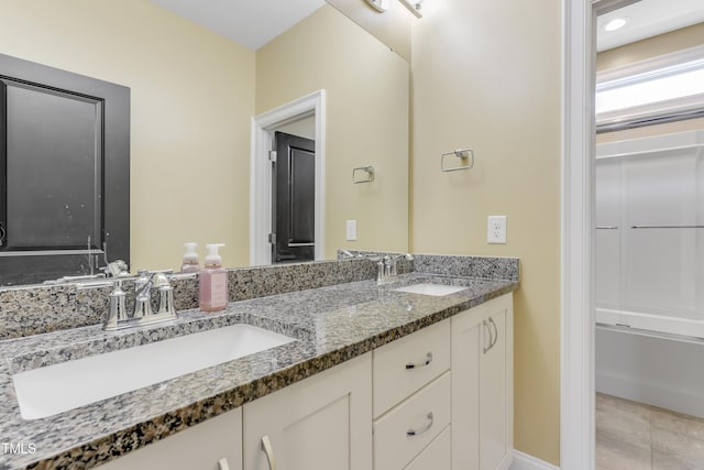 bathroom with a sink and double vanity