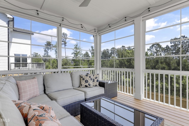 sunroom / solarium with an outdoor living space, a ceiling fan, and plenty of natural light