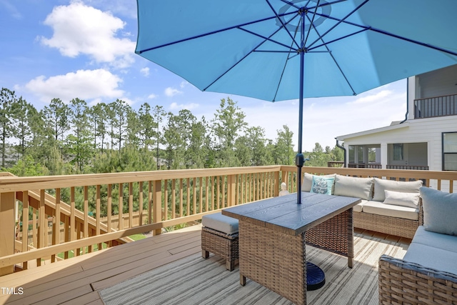 wooden terrace featuring outdoor dining space, a sunroom, and outdoor lounge area