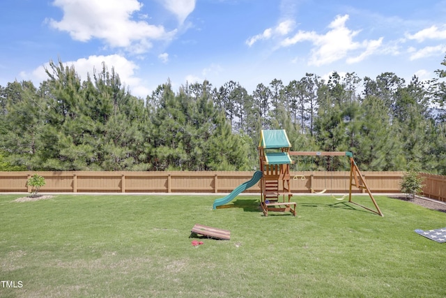 view of playground featuring a yard and a fenced backyard